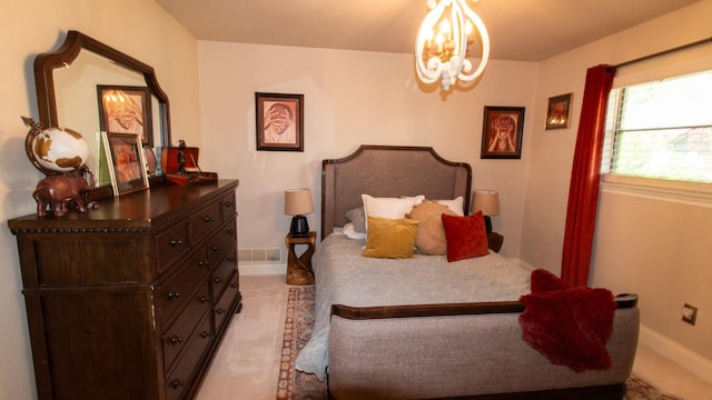 bedroom featuring visible vents, light colored carpet, baseboards, and an inviting chandelier