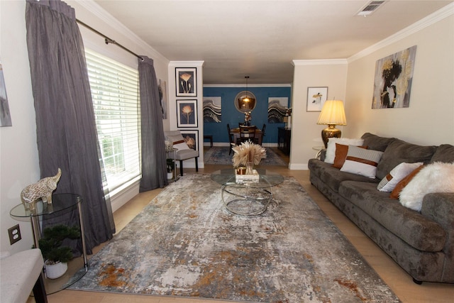 living room featuring visible vents, baseboards, and ornamental molding