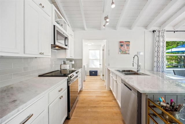 kitchen featuring backsplash, light wood-type flooring, beam ceiling, appliances with stainless steel finishes, and a sink