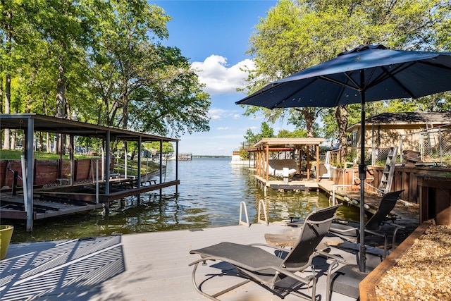 view of dock with boat lift and a water view