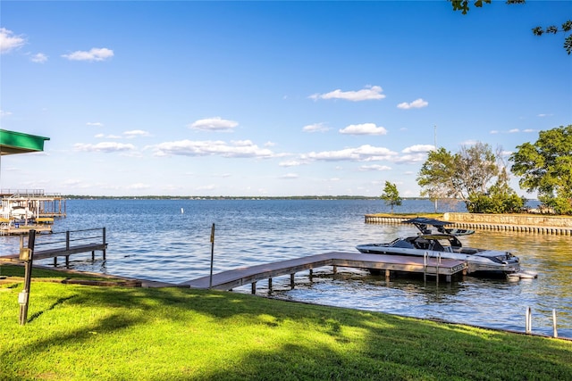 dock area featuring a water view and a lawn