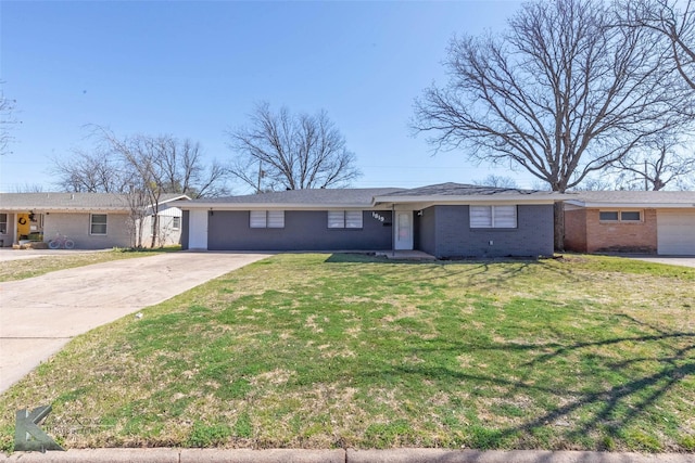 single story home with concrete driveway, brick siding, and a front lawn