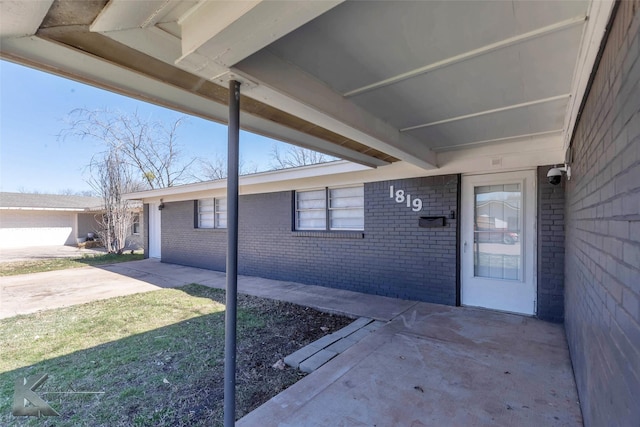 property entrance featuring brick siding