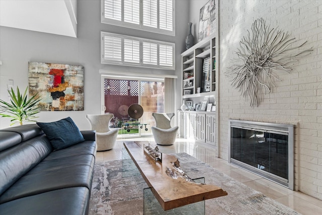 living room featuring tile patterned flooring, a high ceiling, and a fireplace