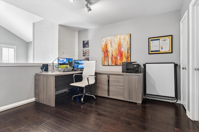 office area with dark wood finished floors, vaulted ceiling, rail lighting, and baseboards