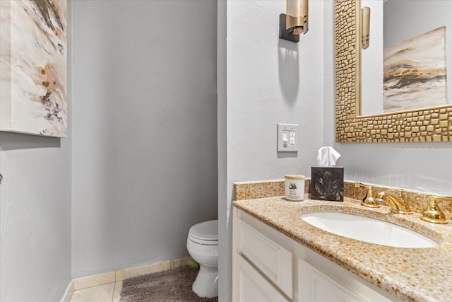 bathroom featuring tile patterned floors, toilet, vanity, and baseboards