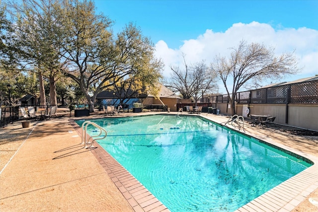 pool featuring a patio and fence