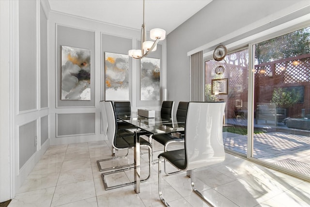 dining room with an inviting chandelier and a decorative wall