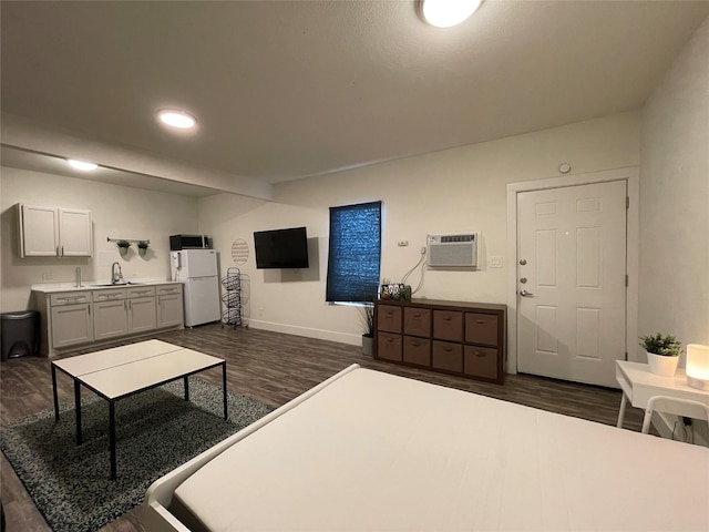 living room featuring baseboards, dark wood-style floors, and a wall unit AC