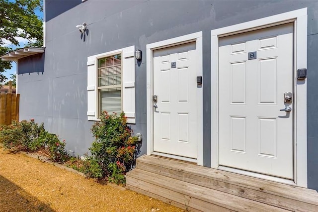 view of exterior entry featuring stucco siding