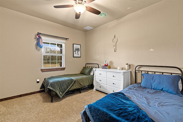 bedroom featuring a ceiling fan, baseboards, visible vents, and light carpet