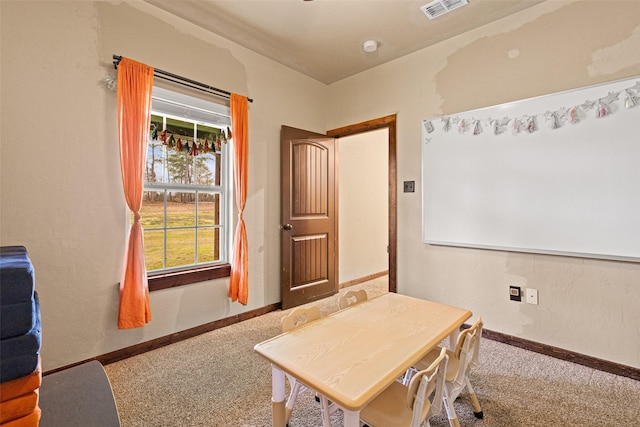 carpeted office space featuring visible vents and baseboards