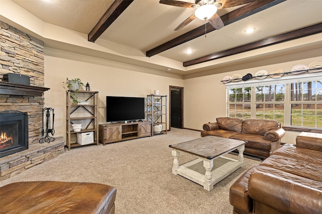 carpeted living room featuring a ceiling fan, beamed ceiling, recessed lighting, and a fireplace