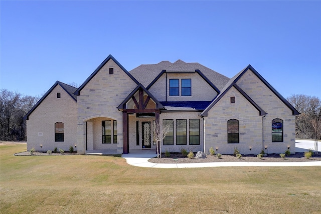 view of front of home with stone siding and a front lawn