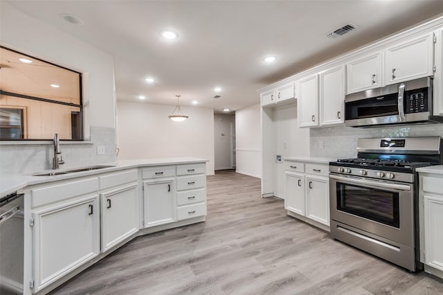 kitchen with visible vents, light countertops, appliances with stainless steel finishes, light wood-style floors, and white cabinetry