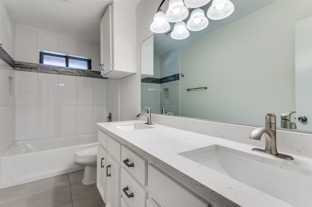 full bathroom with tile patterned floors, toilet, double vanity, and a sink