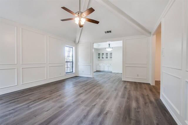 interior space featuring visible vents, dark wood finished floors, lofted ceiling with beams, a decorative wall, and a ceiling fan