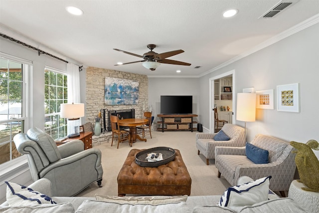 living room featuring visible vents, carpet, ornamental molding, and a fireplace