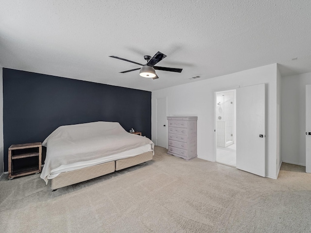 bedroom featuring ceiling fan, carpet flooring, visible vents, and a textured ceiling