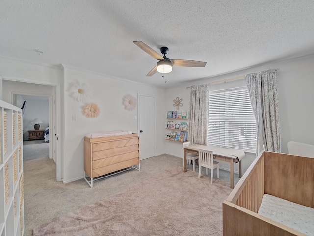 carpeted bedroom with a ceiling fan, baseboards, and a textured ceiling