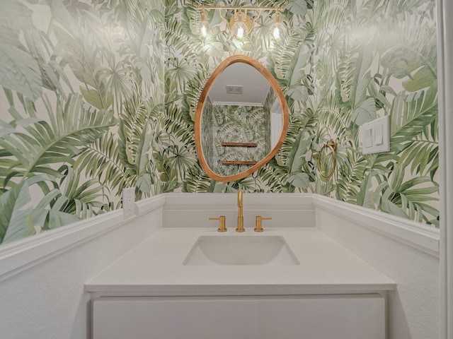 bathroom featuring wallpapered walls and vanity