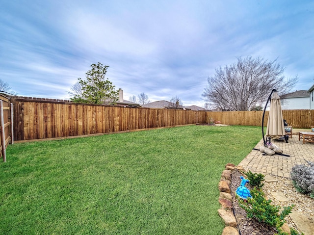 view of yard featuring a patio and a fenced backyard