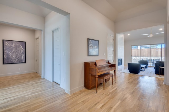 hallway featuring baseboards and light wood finished floors