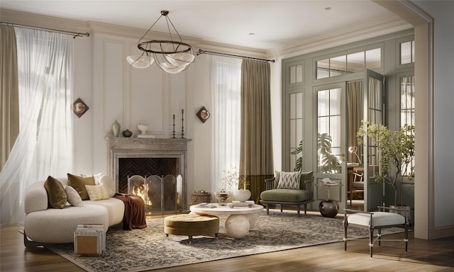 living area featuring a lit fireplace, a healthy amount of sunlight, wood finished floors, and crown molding