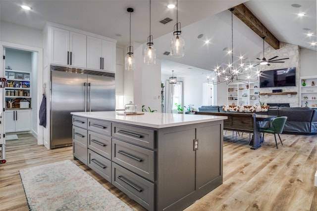 kitchen featuring visible vents, vaulted ceiling with beams, stainless steel built in refrigerator, light wood-type flooring, and gray cabinets