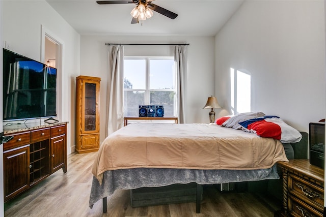 bedroom with ceiling fan and light wood-style floors