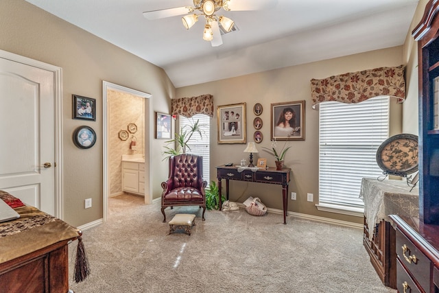 living area featuring baseboards, carpet flooring, a ceiling fan, and lofted ceiling