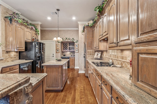 kitchen with black appliances, light stone countertops, and ornamental molding