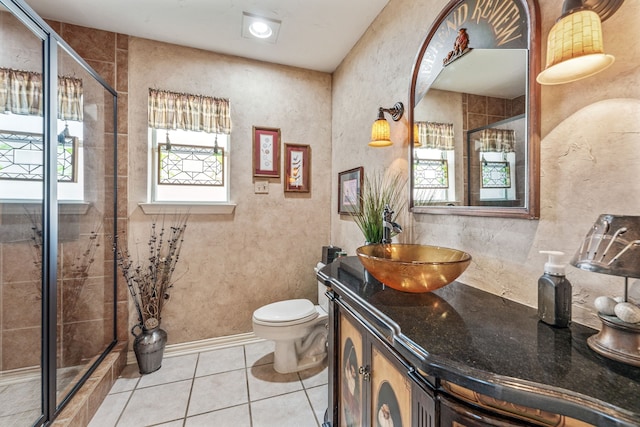 full bath featuring tile patterned flooring, toilet, vanity, and a stall shower