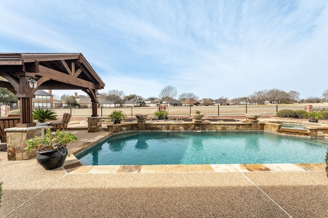 view of swimming pool with a gazebo, a patio area, a fenced backyard, and a pool with connected hot tub