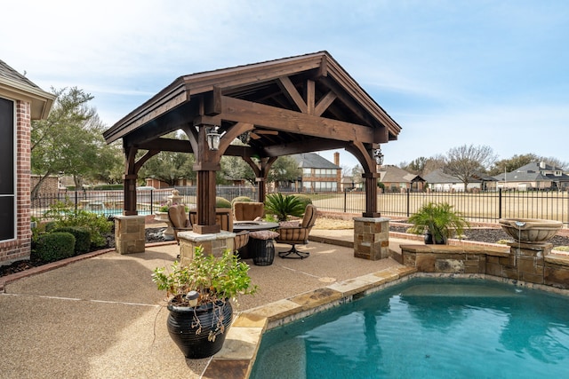 view of pool featuring a gazebo, a patio area, a fenced backyard, and a fenced in pool