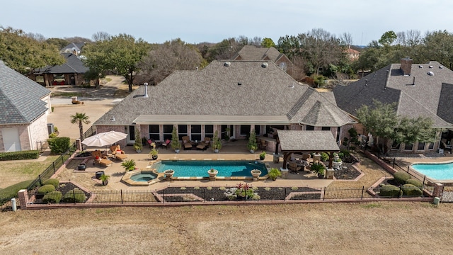 view of pool with a gazebo, a patio area, a pool with connected hot tub, and a fenced backyard