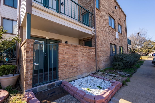 property entrance featuring brick siding