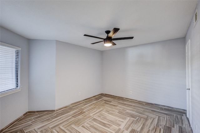 spare room with a ceiling fan and light wood finished floors