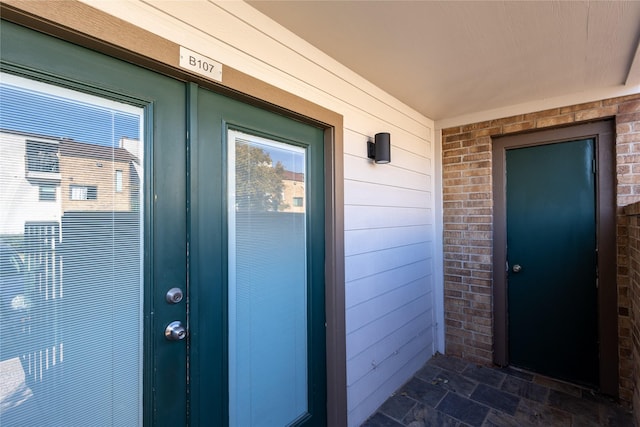 entrance to property with brick siding