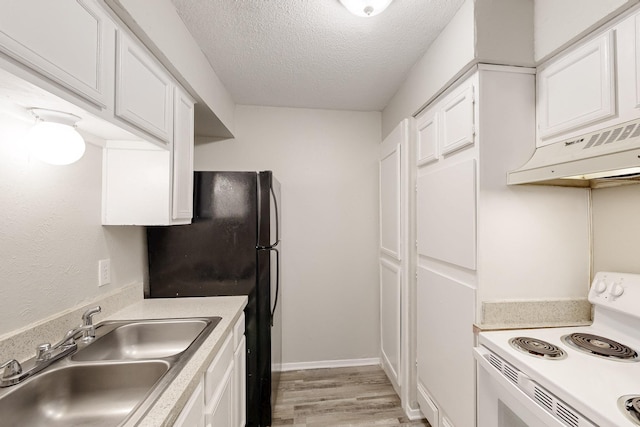 kitchen with under cabinet range hood, electric stove, white cabinets, a textured ceiling, and a sink