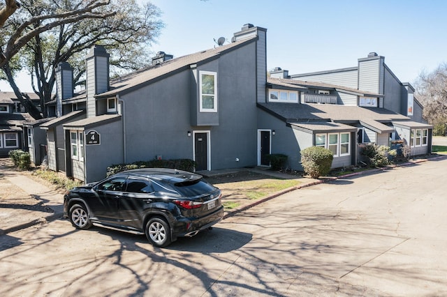 view of side of property featuring a residential view and a chimney