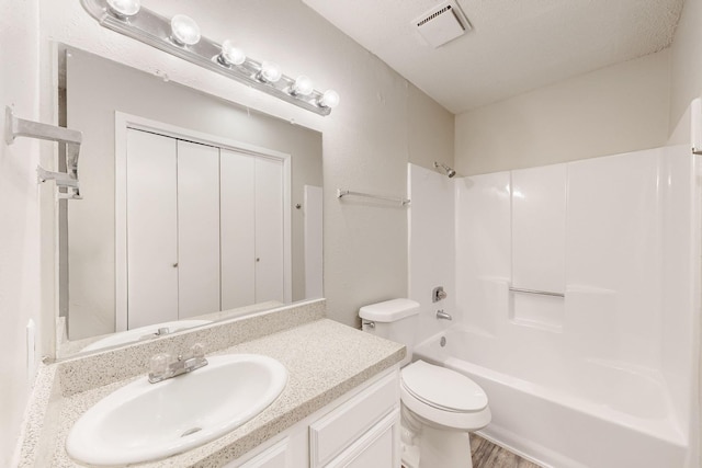 full bathroom with vanity, toilet, visible vents, and shower / bath combination