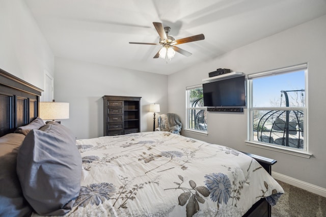 carpeted bedroom featuring baseboards and a ceiling fan