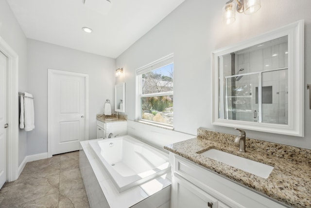 full bathroom featuring a sink, two vanities, a bath, and a shower stall