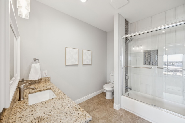 bathroom with tile patterned flooring, baseboards, toilet, enclosed tub / shower combo, and vanity