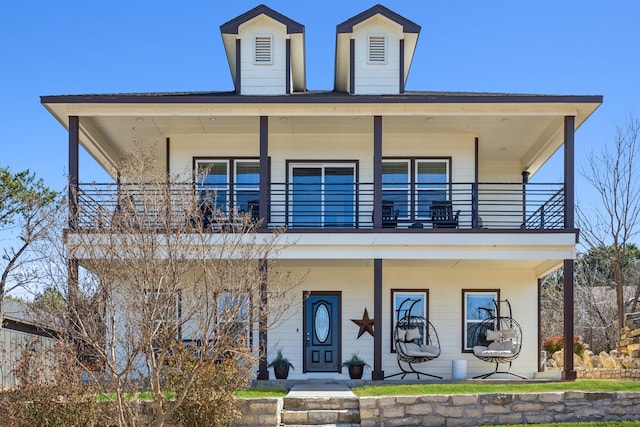 view of front of house featuring a porch and a balcony