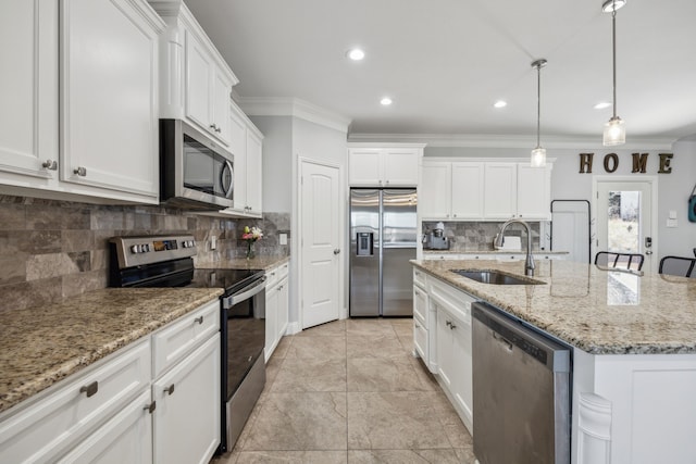 kitchen featuring white cabinets, stainless steel appliances, ornamental molding, and a sink