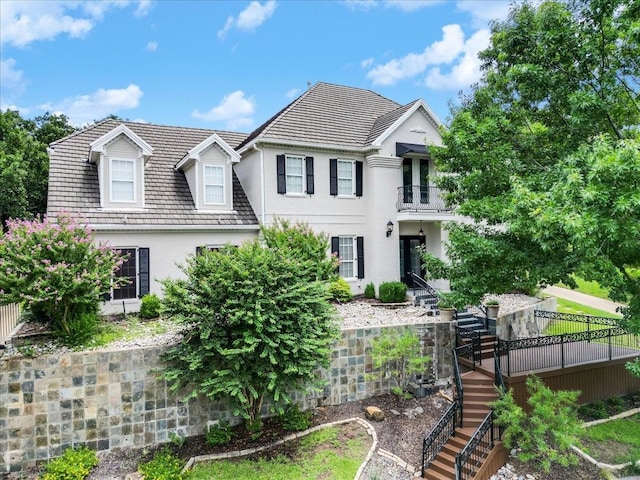 view of front of property with stairway and stucco siding