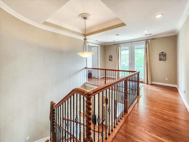 stairway featuring visible vents, baseboards, ornamental molding, french doors, and wood finished floors