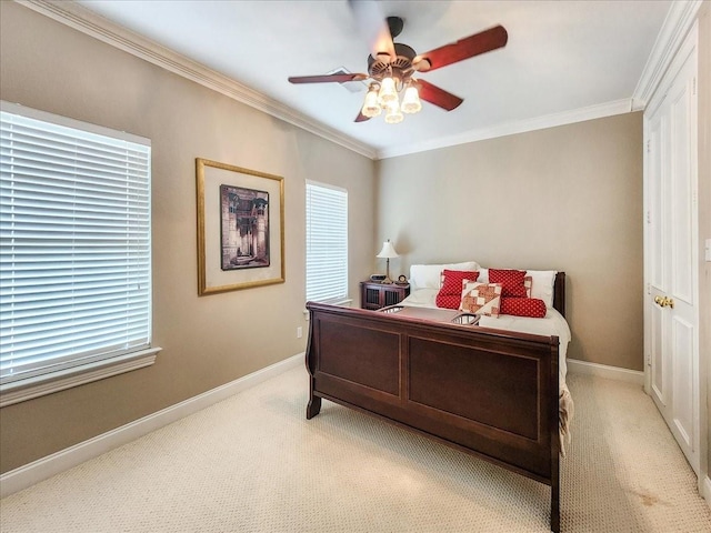 bedroom featuring light colored carpet, a ceiling fan, baseboards, and ornamental molding